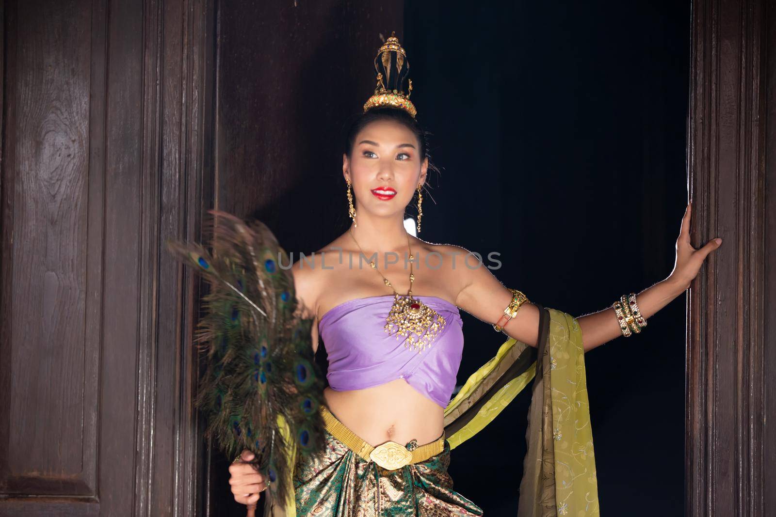 Thailand or Thai costume Asian dress concept. Young Thai beautiful woman is walking in the Buddhist temple in Ayutthaya. by chuanchai