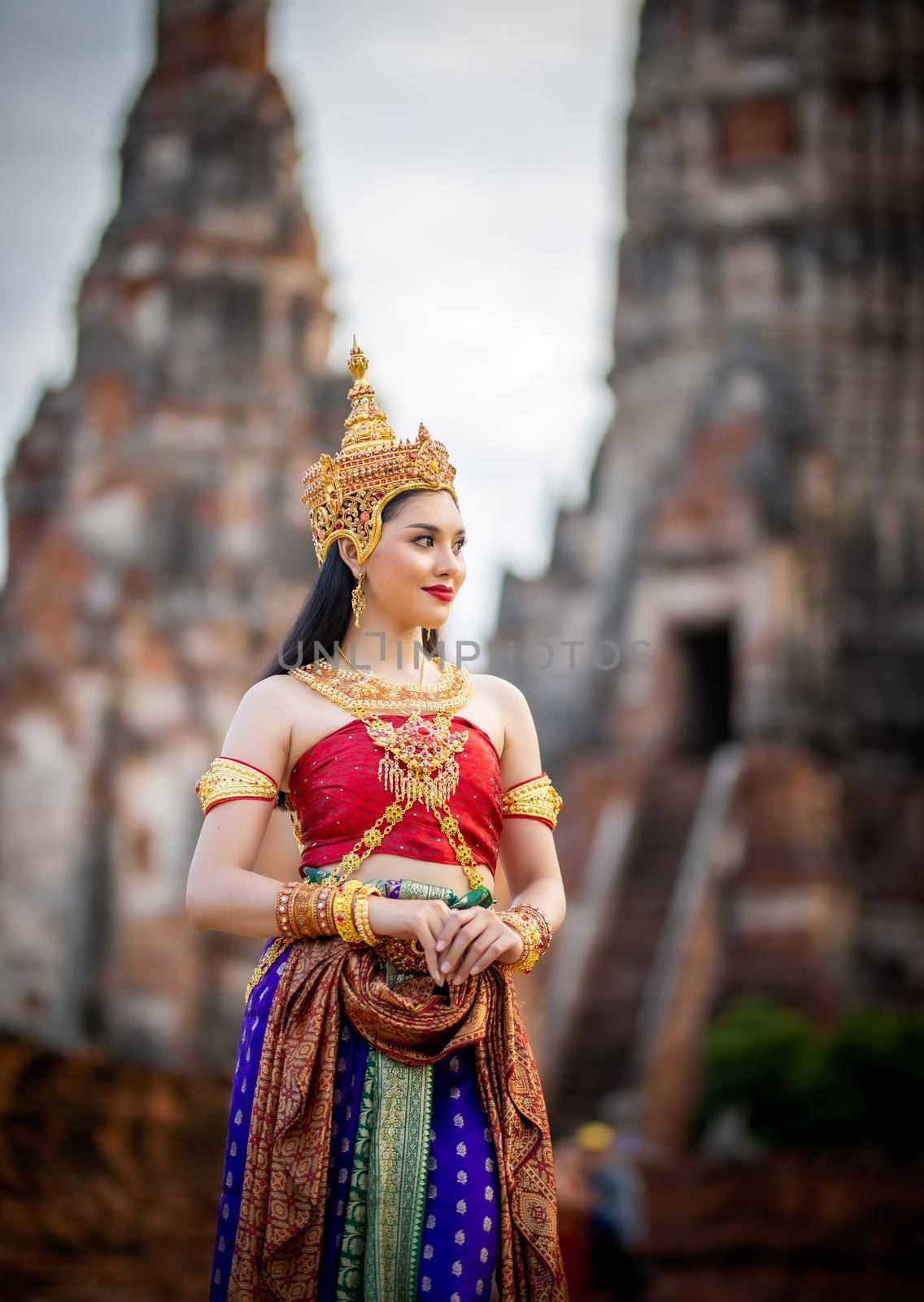 Thailand or Thai costume Asian dress concept. Young Thai beautiful woman is walking in the Buddhist temple in Ayutthaya. by chuanchai