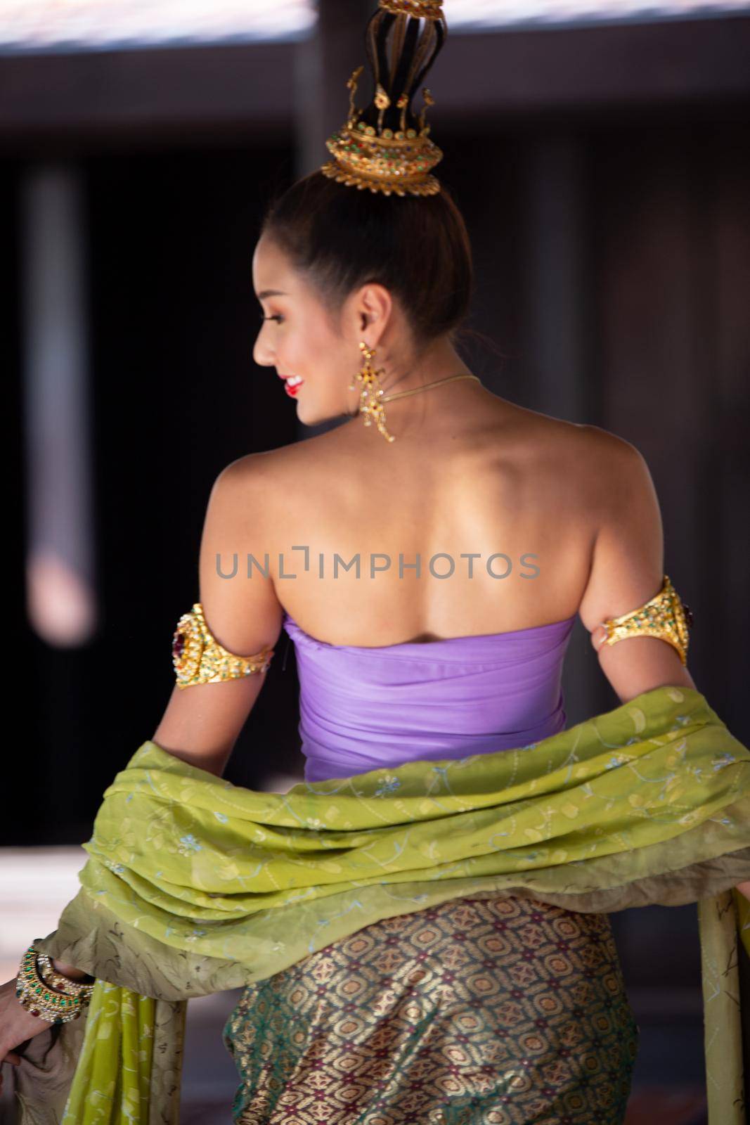 Thailand or Thai costume Asian dress concept. Young Thai beautiful woman is walking in the Buddhist temple in Ayutthaya. by chuanchai