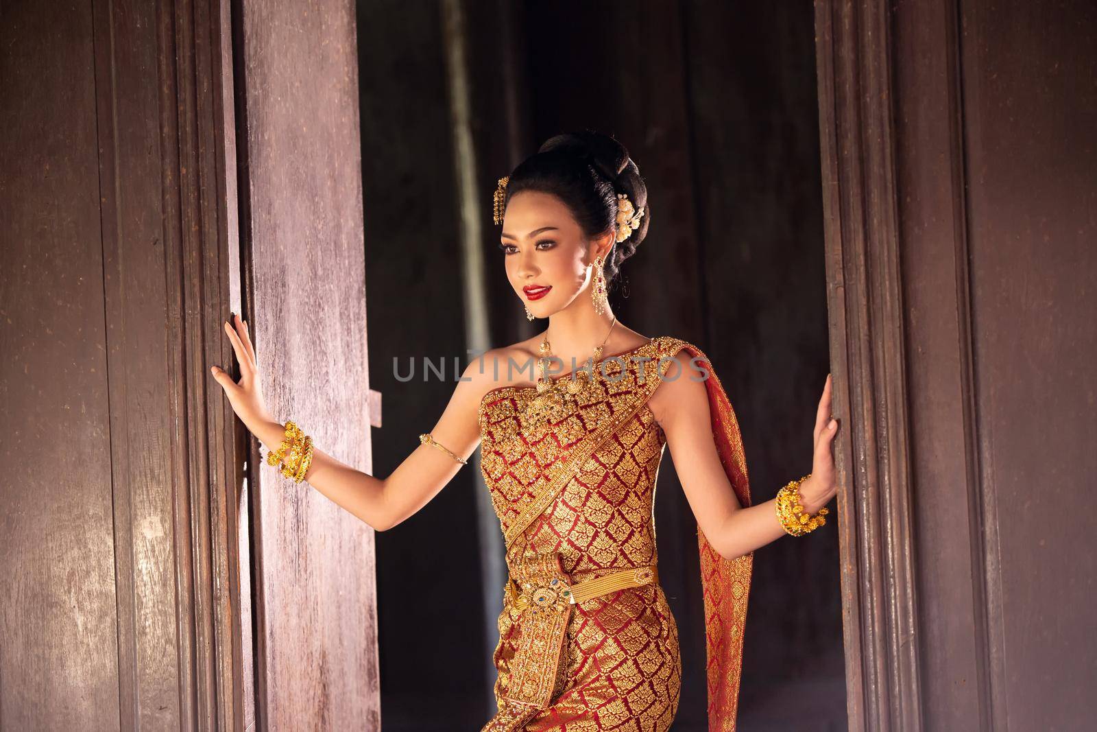 Thailand or Thai costume Asian dress concept. Young Thai beautiful woman is walking in the Buddhist temple in Ayutthaya. by chuanchai