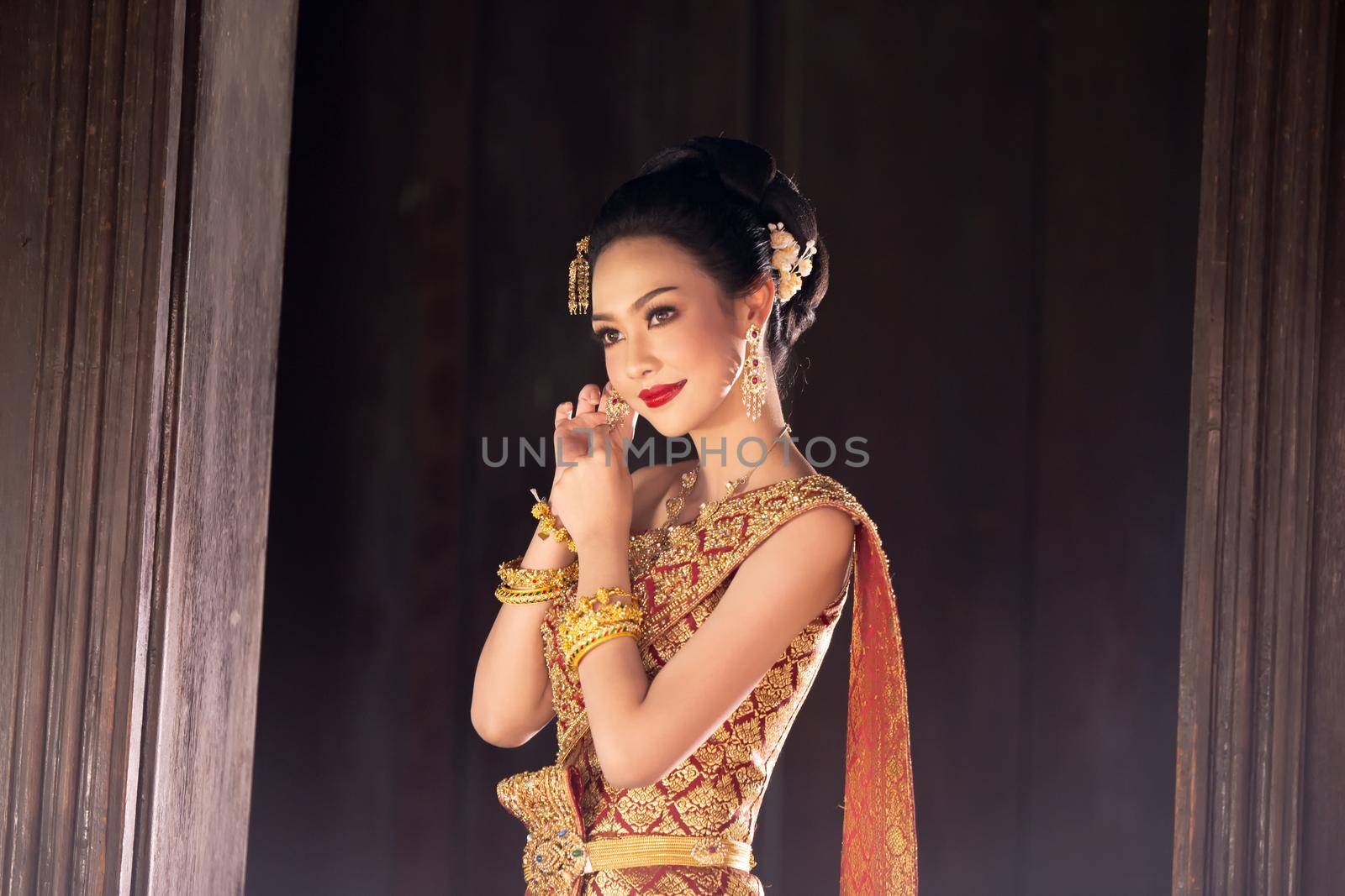 Thailand or Thai costume Asian dress concept. Young Thai beautiful woman is walking in the Buddhist temple in Ayutthaya. by chuanchai