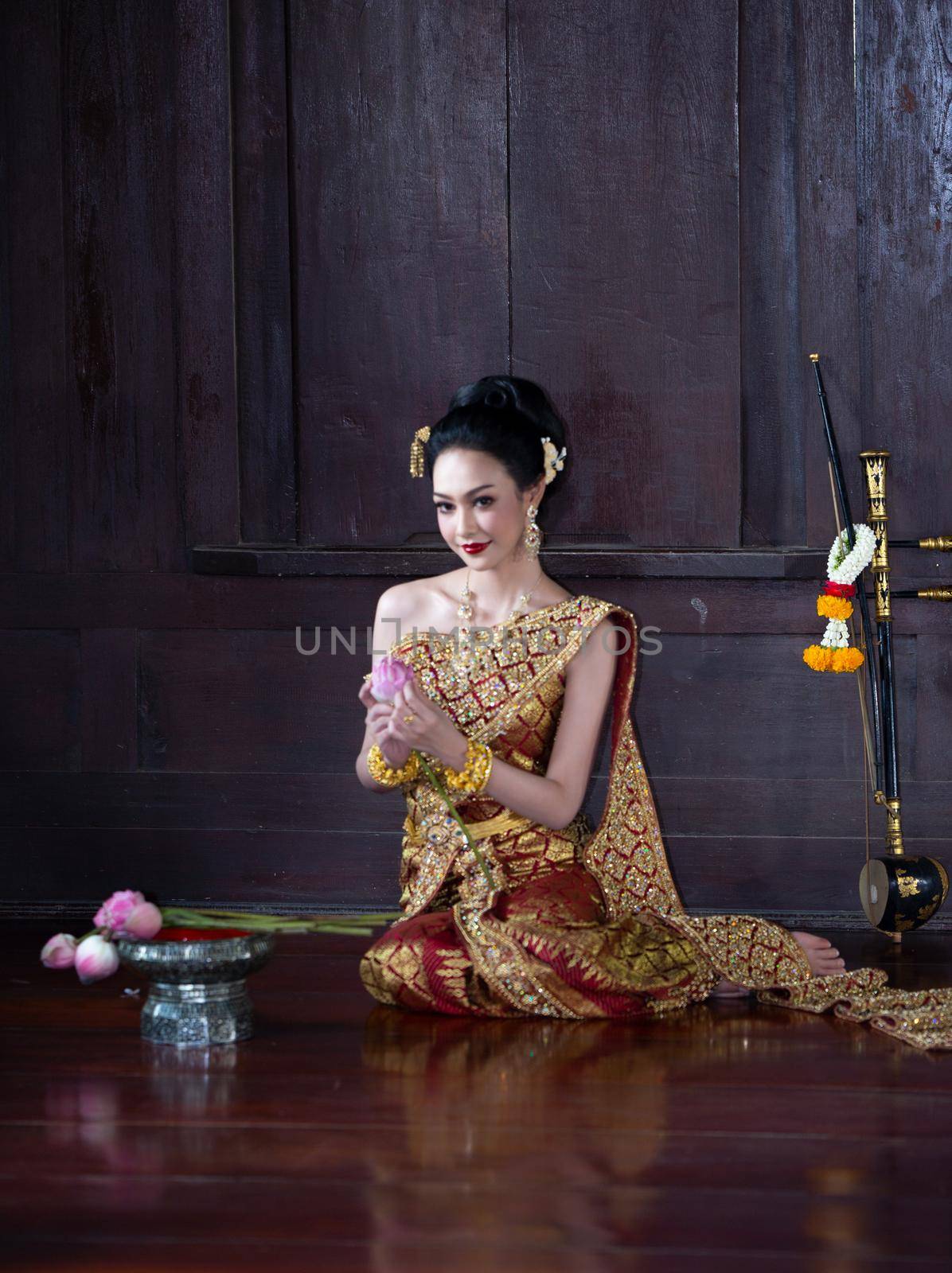 Thailand or Thai costume Asian dress concept. Young Thai beautiful woman is walking in the Buddhist temple in Ayutthaya. by chuanchai