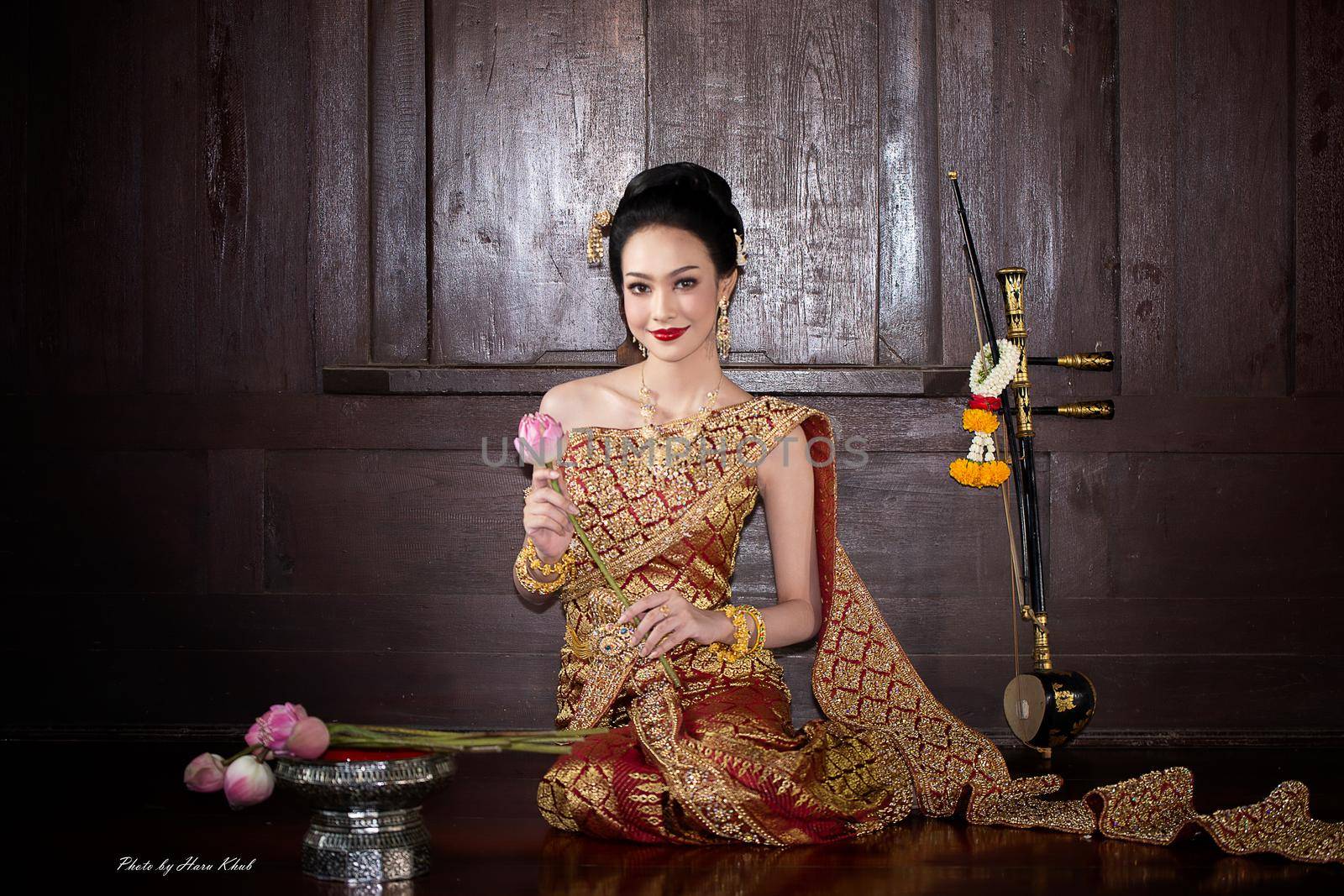 Thailand or Thai costume Asian dress concept. Young Thai beautiful woman is walking in the Buddhist temple in Ayutthaya. by chuanchai