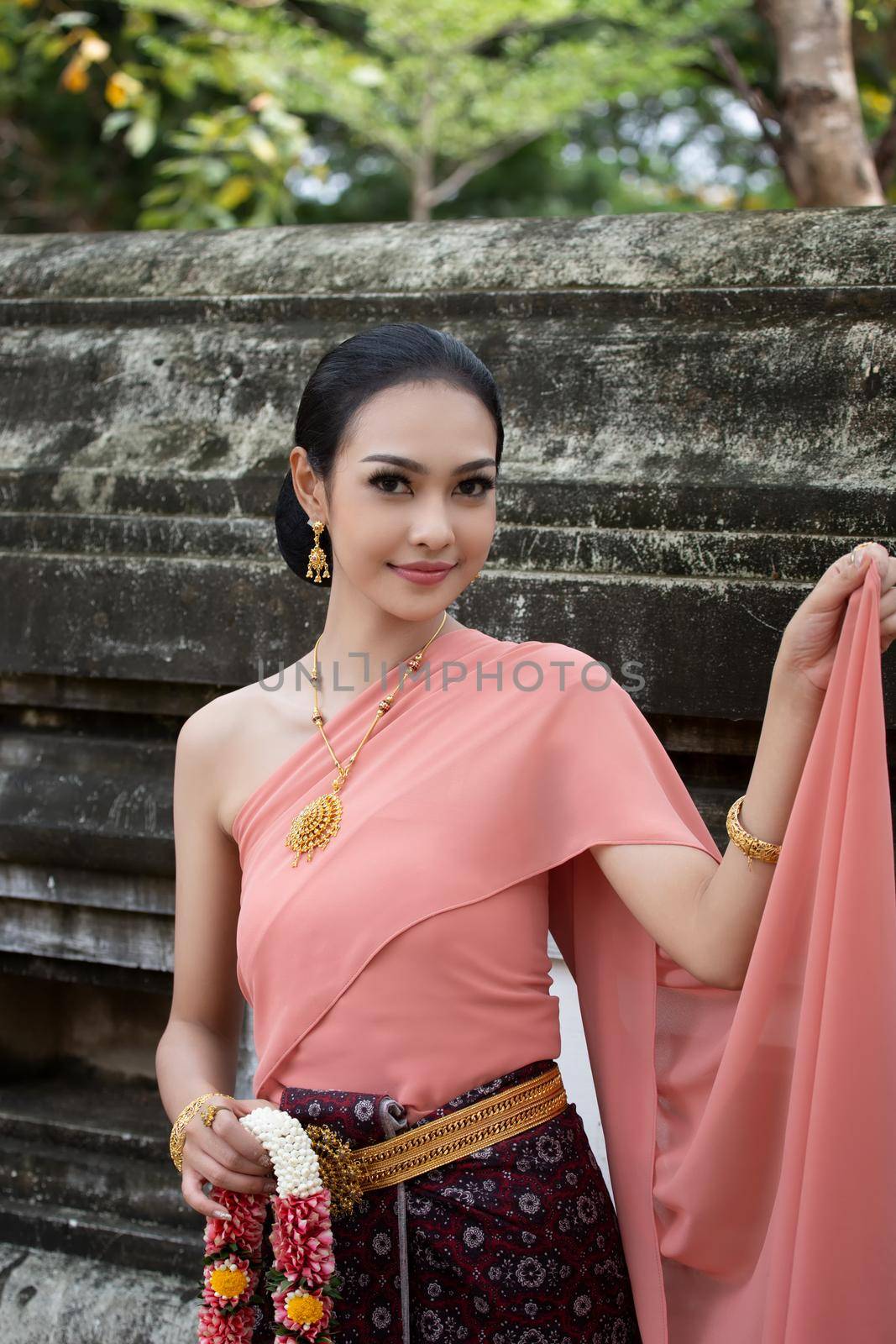 Thailand or Thai costume Asian dress concept. Young Thai beautiful woman is walking in the Buddhist temple in Ayutthaya. by chuanchai