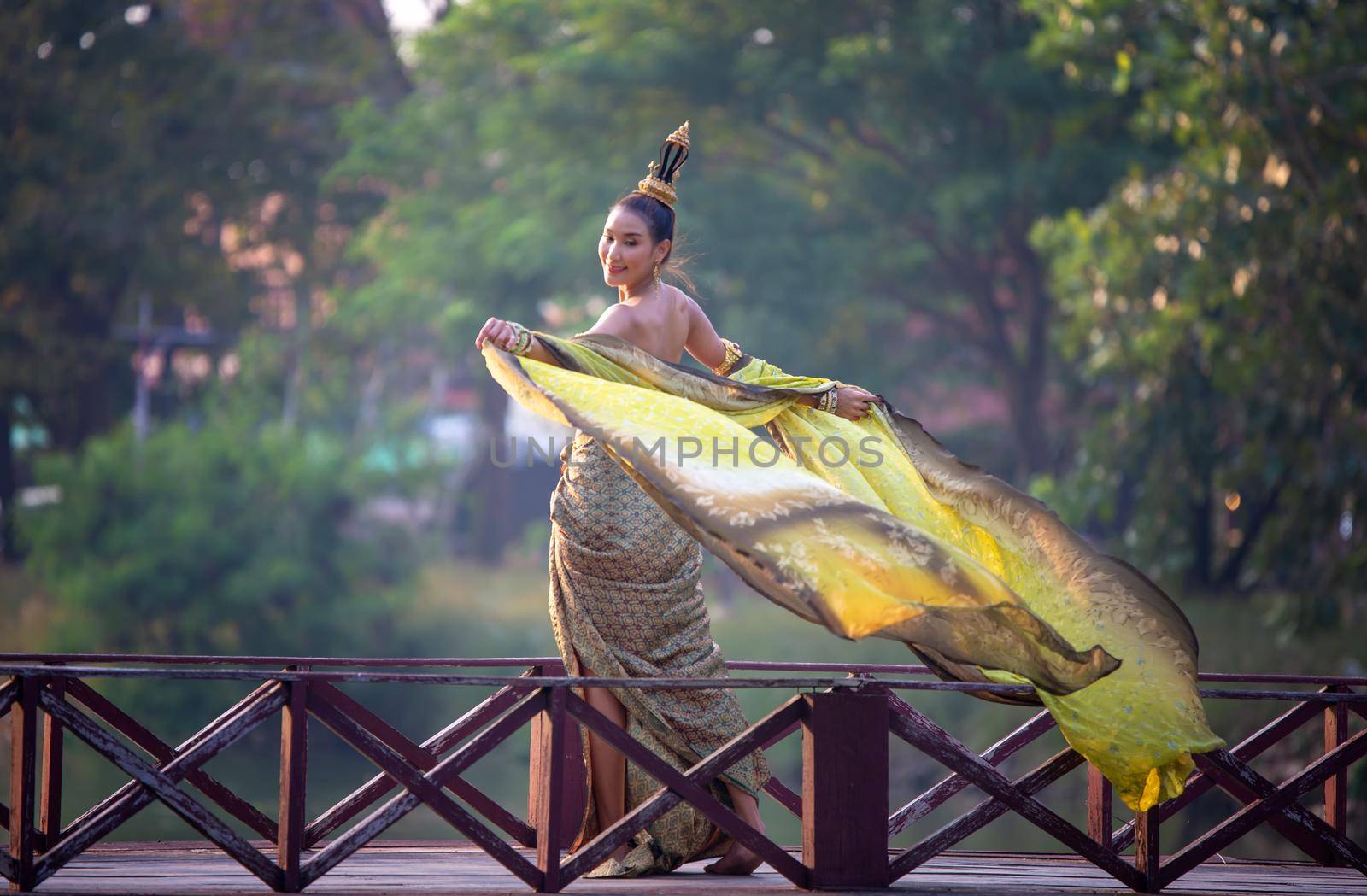 Thailand or Thai costume Asian dress concept. Young Thai beautiful woman is walking in the Buddhist temple in Ayutthaya. by chuanchai