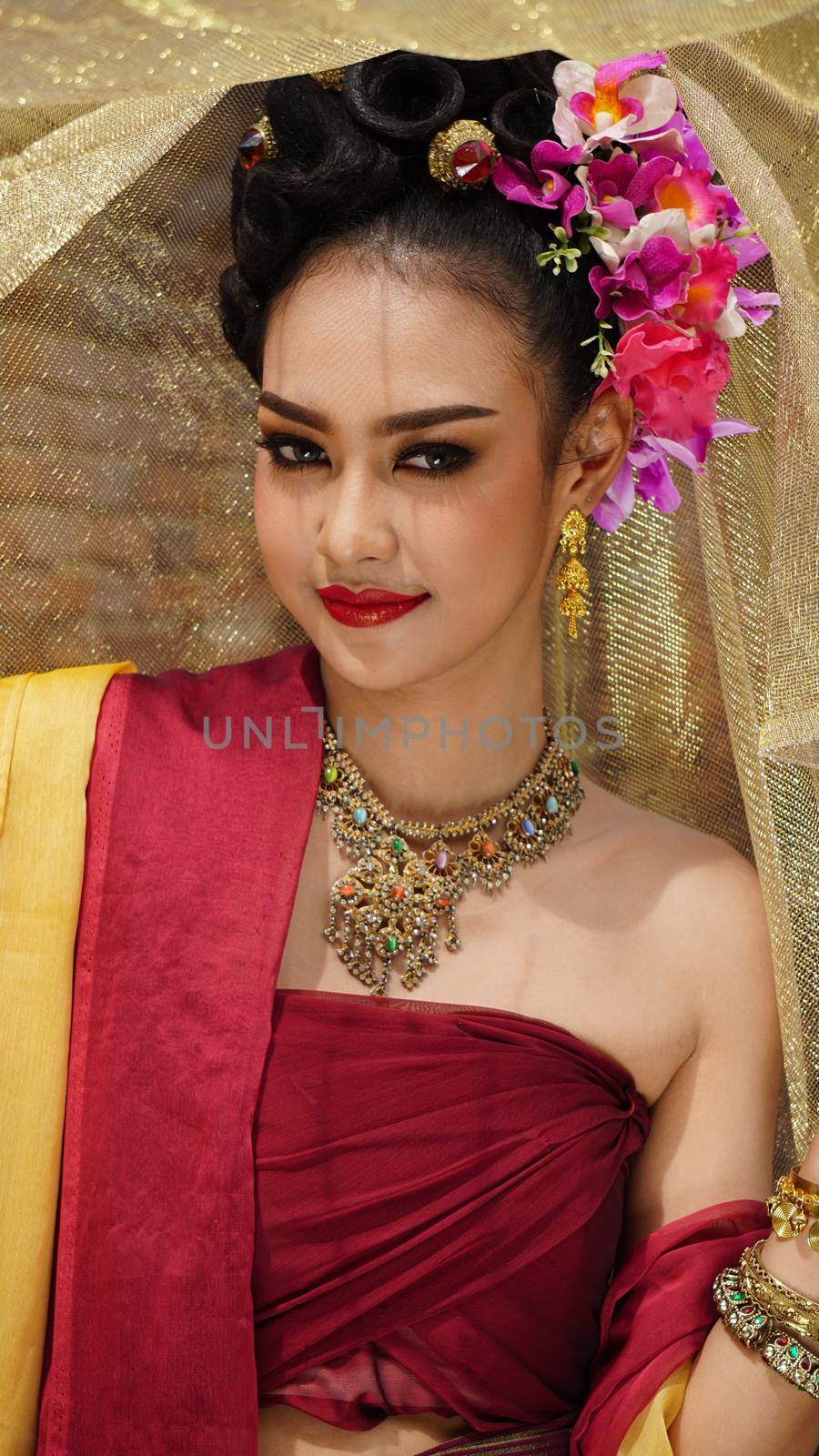 Thailand or Thai costume Asian dress concept. Young Thai beautiful woman is walking in the Buddhist temple in Ayutthaya. by chuanchai