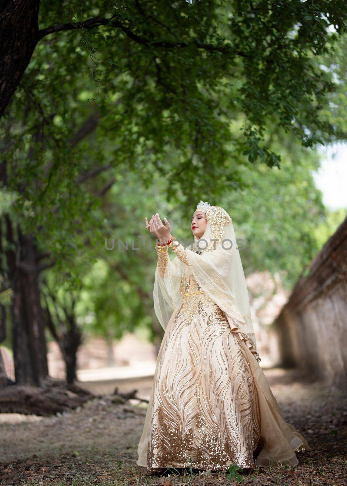 Portrait Of Young Bride Wearing wedding Hijab Standing outdoor by chuanchai