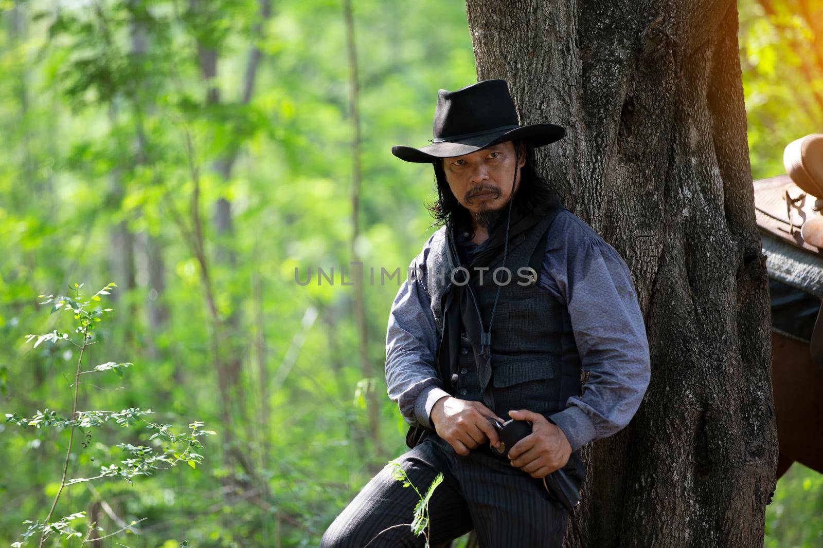 cowboy and horse at first light,mountain, river and lifestyle with natural light background	