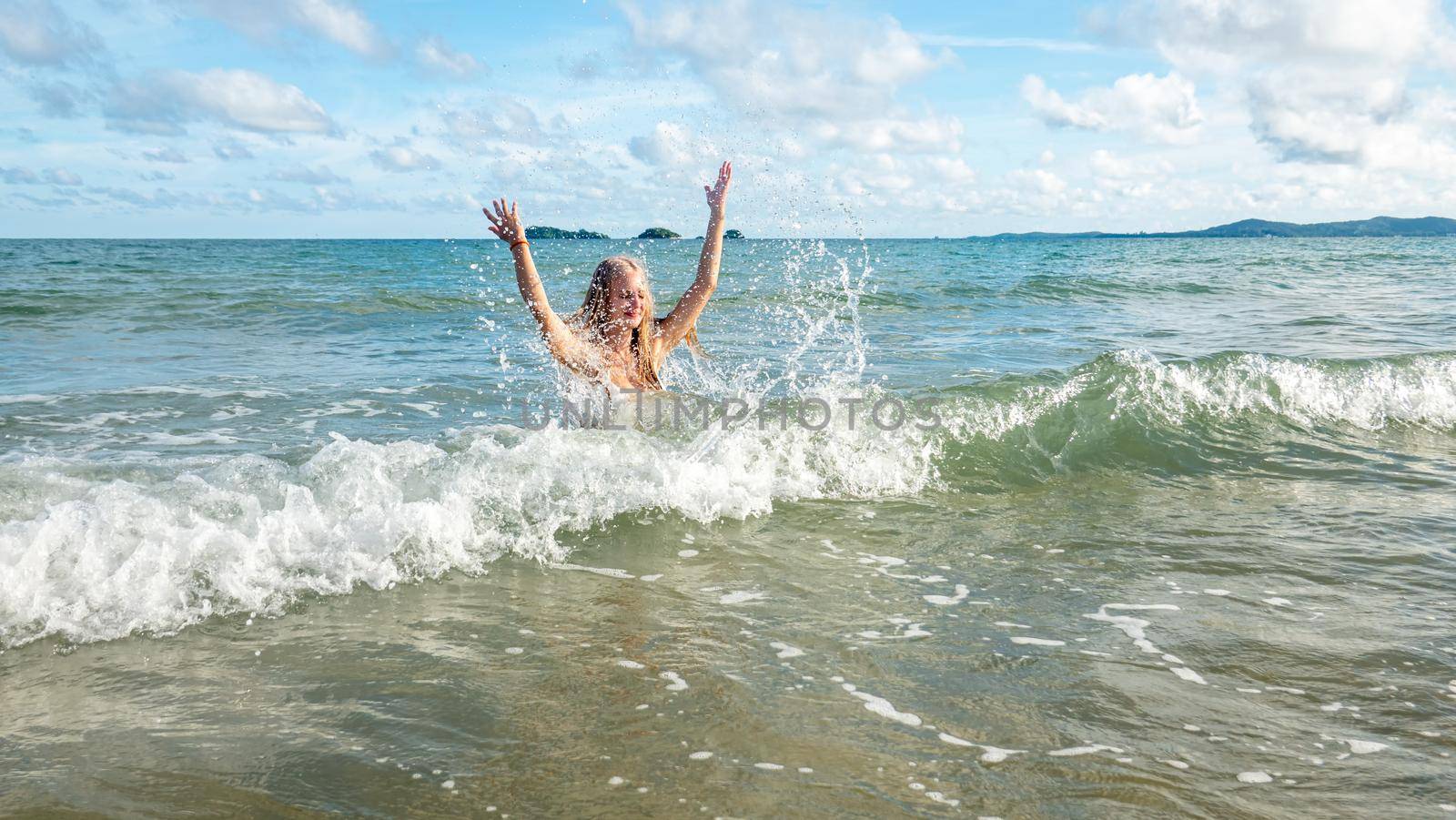 Beautiful young woman in sexy bikini on sand at sea beach.