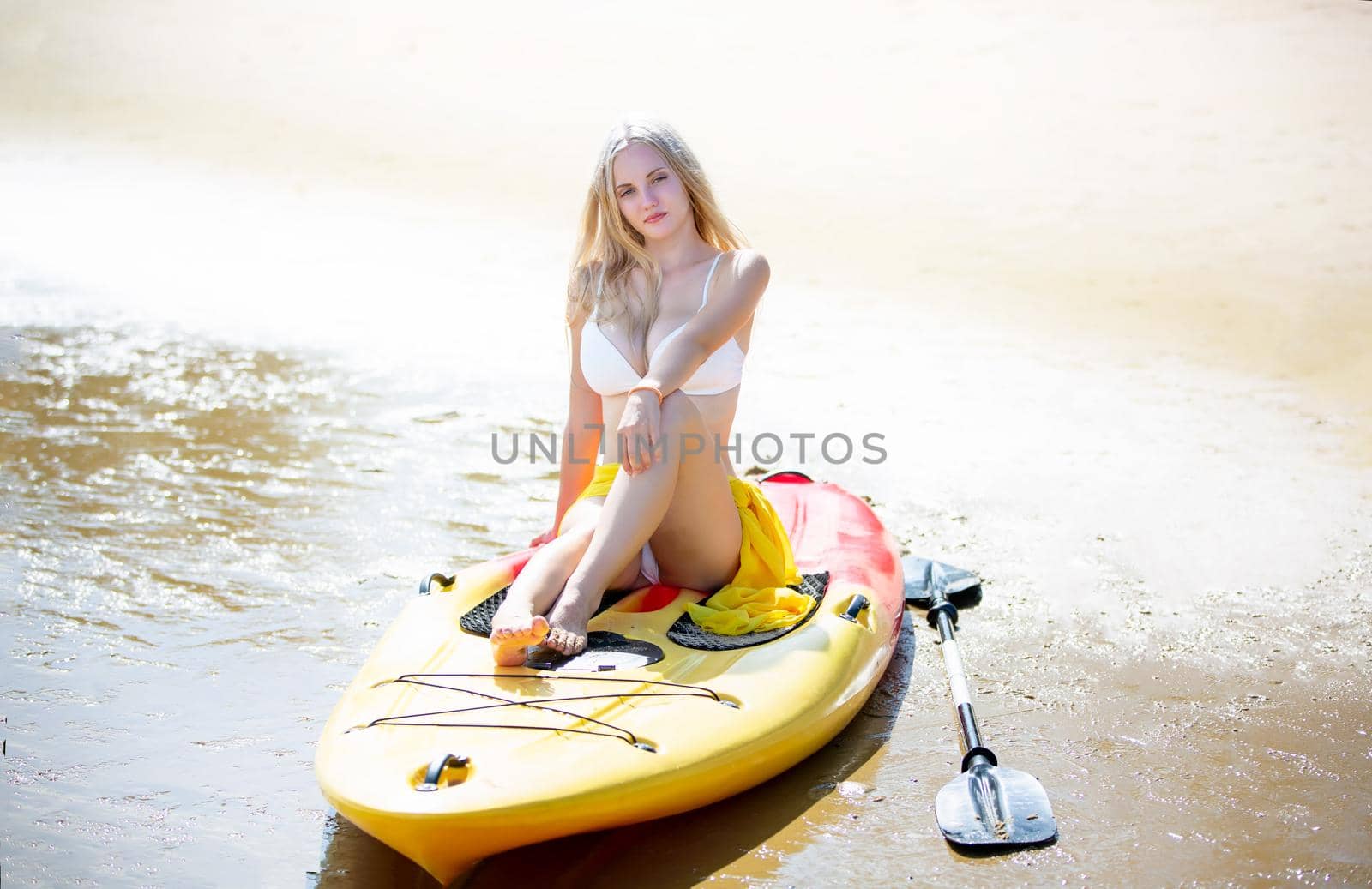 Woman on stand up paddle board. Having fun during warm summer beach vacation holiday, active woman