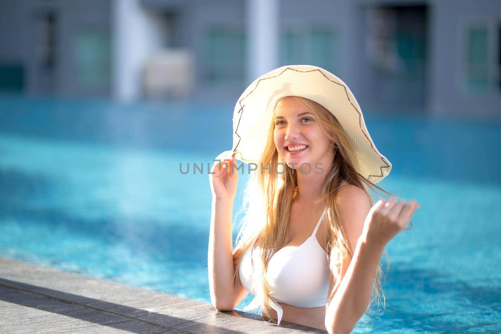 Portrait of a charming sexy woman in lingerie, Sexy young woman with big breast.
women with bikini relaxing summer in the pool.