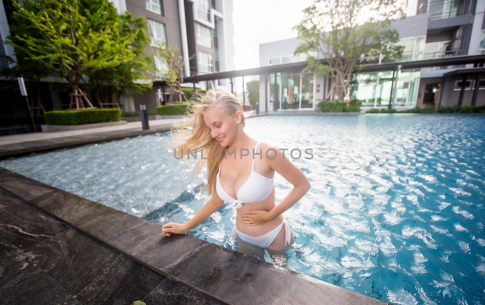 Portrait of a charming sexy woman in lingerie, Sexy young woman with big breast.
women with bikini relaxing summer in the pool. by chuanchai