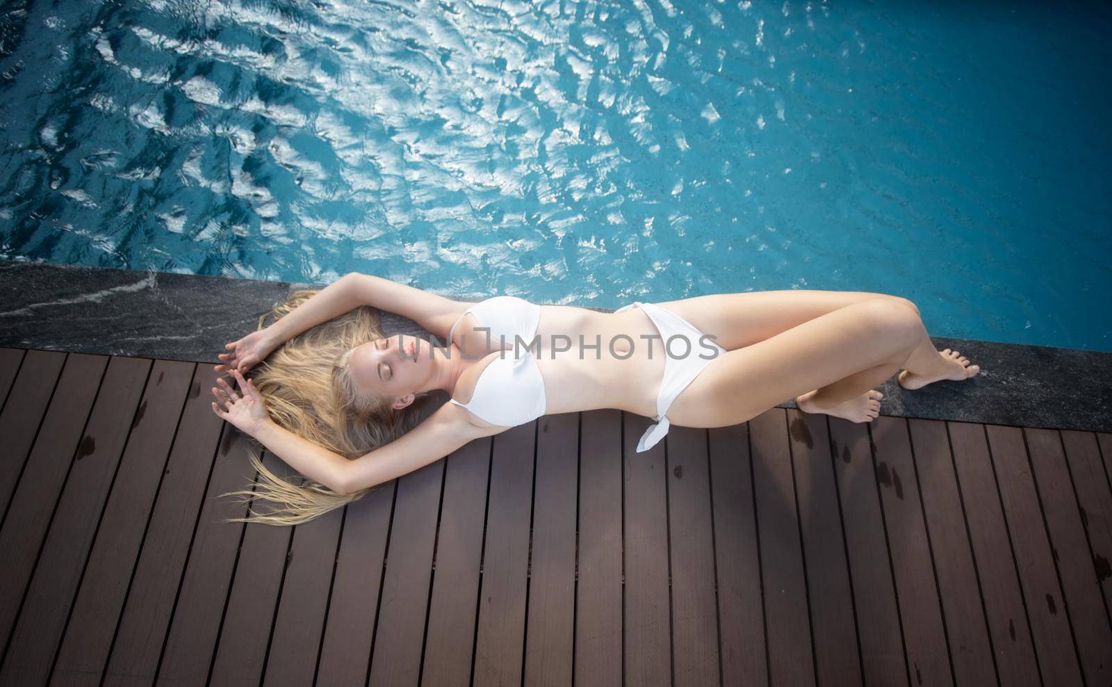 Portrait of a charming sexy woman in lingerie, Sexy young woman with big breast.
women with bikini relaxing summer in the pool.