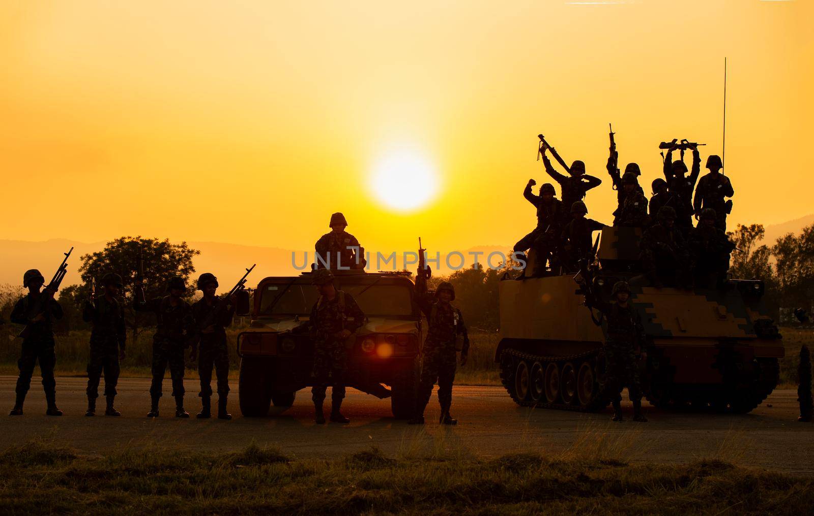 Silhouettes of soldiers during Military Mission at dusk
Silhouettes of army soldiers in the fog against a sunset, marines team in action, surrounded fire and smoke, shooting with assault rifle and machine gun, attacking enemy
 by chuanchai