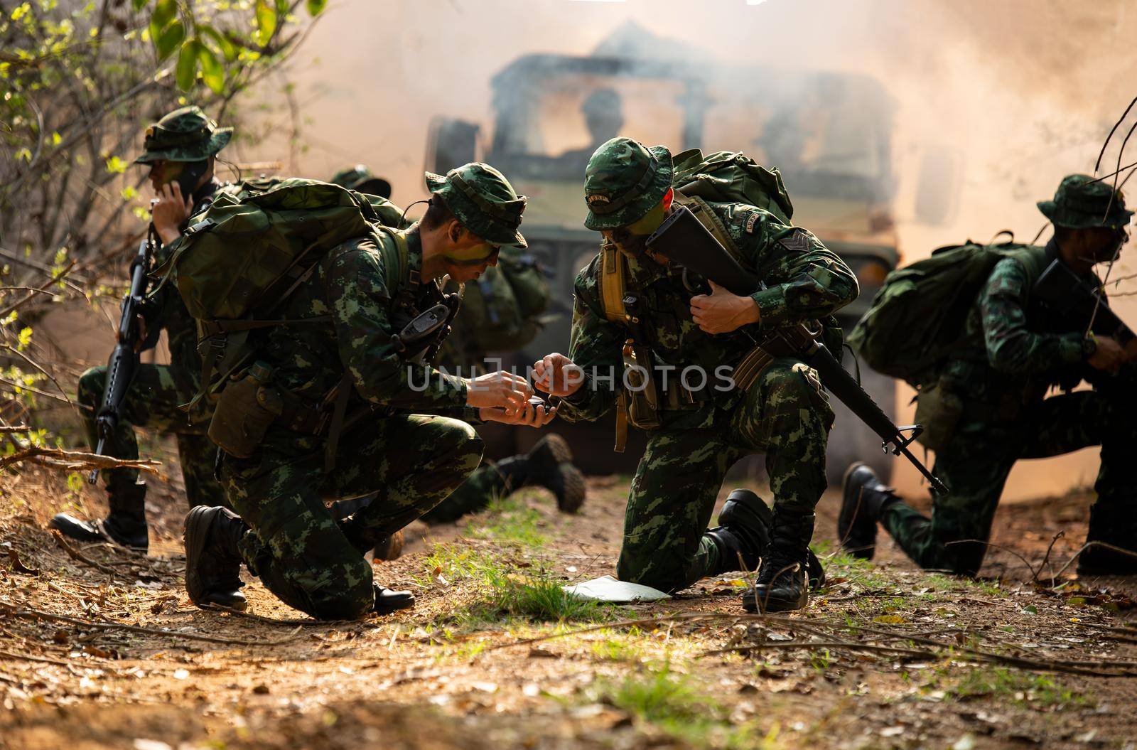 Silhouettes of soldiers during Military Mission at dusk
Silhouettes of army soldiers in the fog against a sunset, marines team in action, surrounded fire and smoke, shooting with assault rifle and machine gun, attacking enemy
 by chuanchai