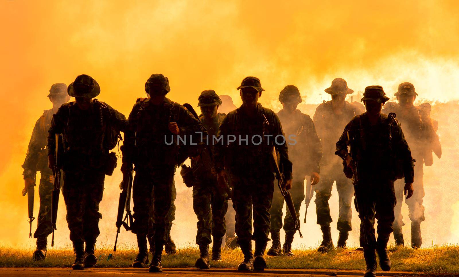 Silhouettes of soldiers during Military Mission at dusk
Silhouettes of army soldiers in the fog against a sunset, marines team in action, surrounded fire and smoke, shooting with assault rifle and machine gun, attacking enemy
 by chuanchai