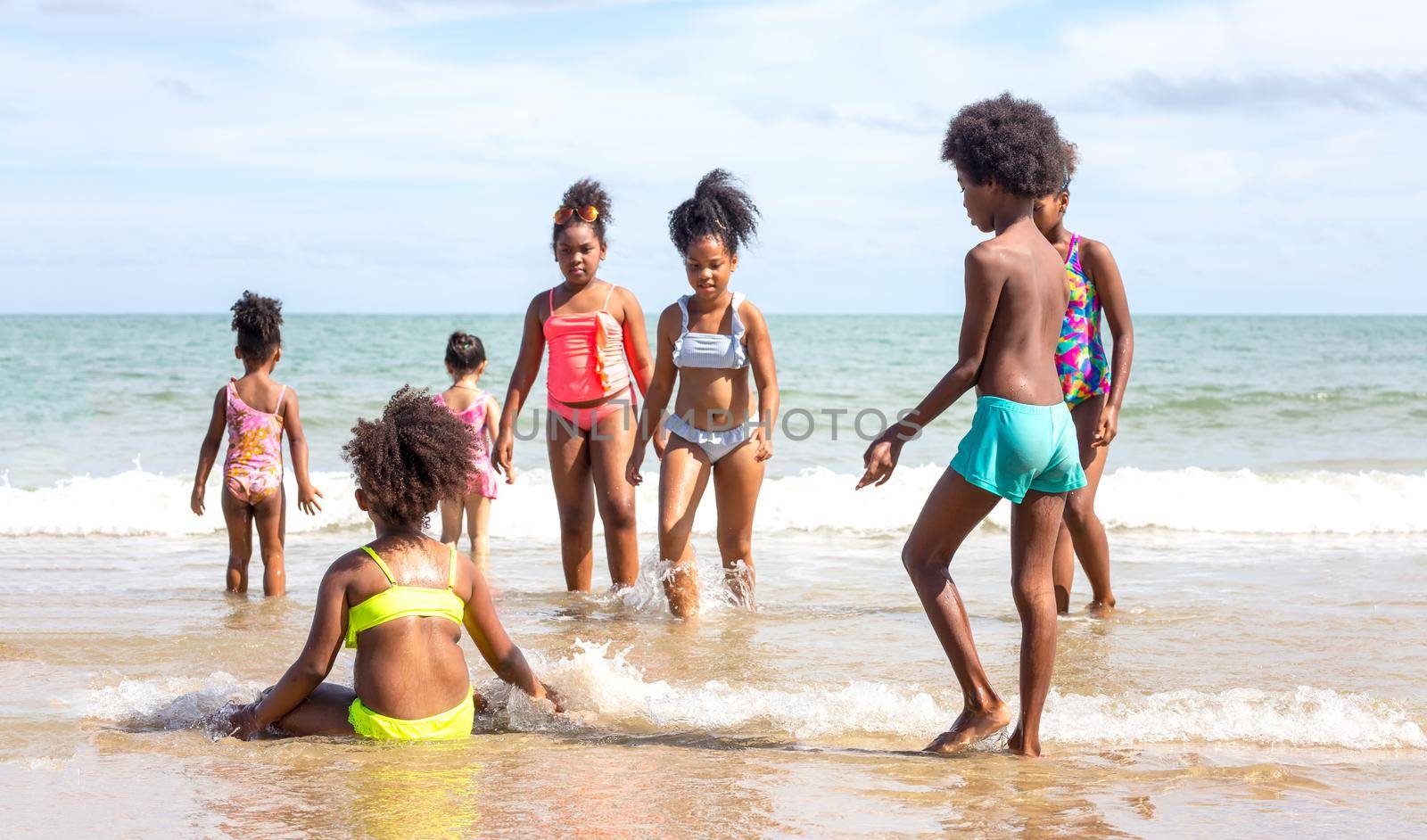 Kids playing running on sand at the beach