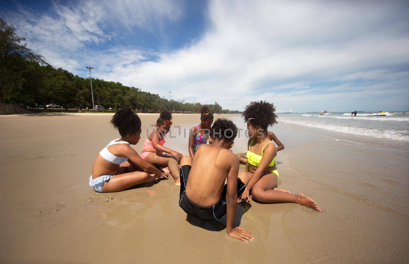 Kids playing running on sand at the beach