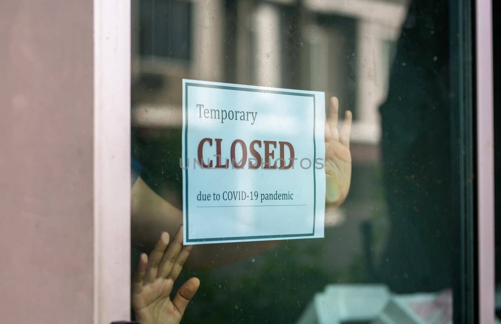 Closed businesses for COVID-19 pandemic outbreak, closure sign on retail store window banner background. Government shutdown of restaurants, shopping stores, non essential services. by chuanchai