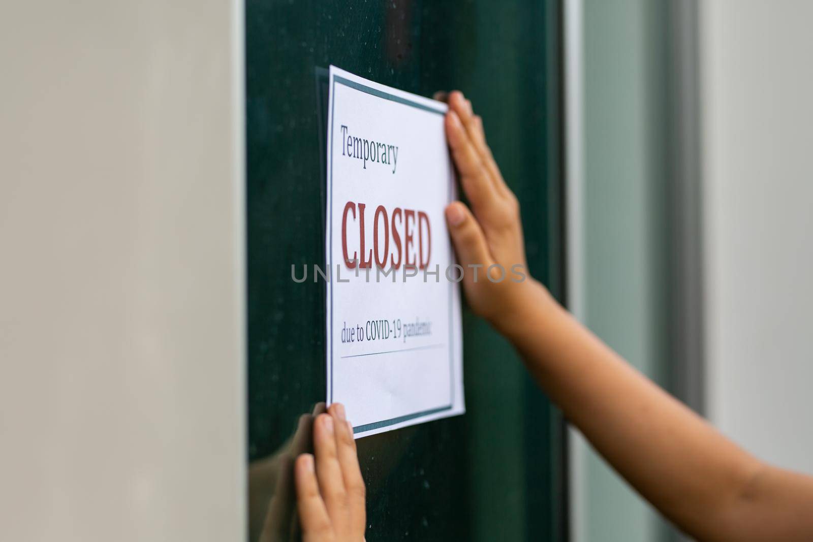 Closed businesses for COVID-19 pandemic outbreak, closure sign on retail store window banner background. Government shutdown of restaurants, shopping stores, non essential services. by chuanchai