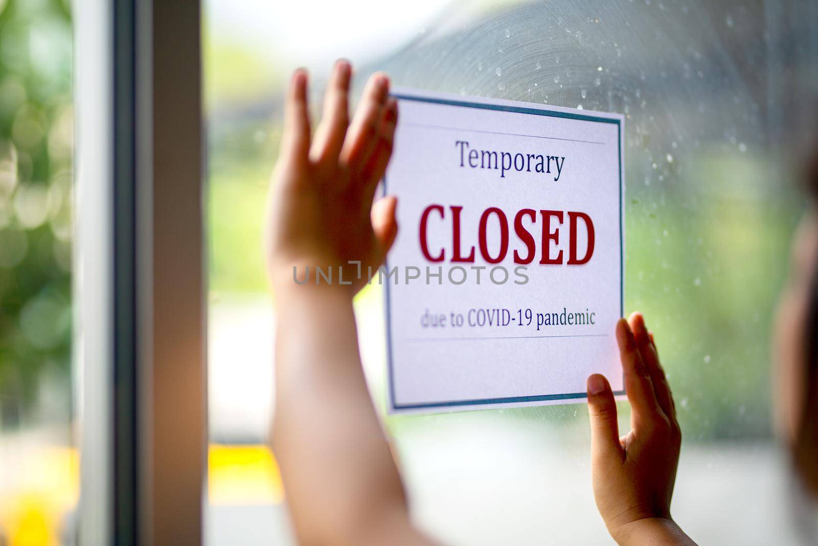 Closed businesses for COVID-19 pandemic outbreak, closure sign on retail store window banner background. Government shutdown of restaurants, shopping stores, non essential services.