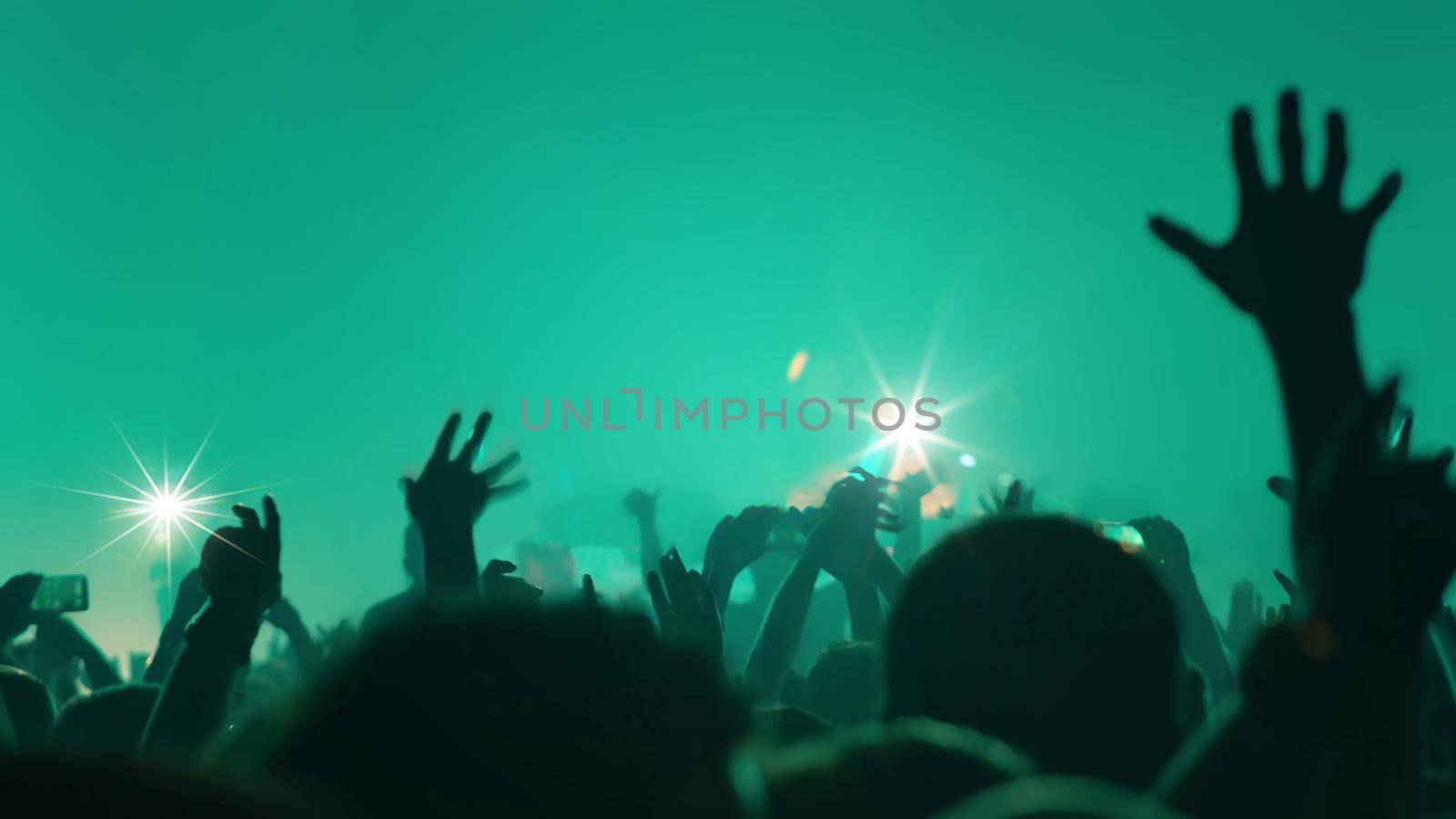 Concert Music festival and Celebrate. Party People Rock Concert. Crowd Happy and Joyful and Applauding or Clapping. Celebration party festival happiness. Blurry night club. Concert Show with DJ Music festival EDM on Stage by chuanchai