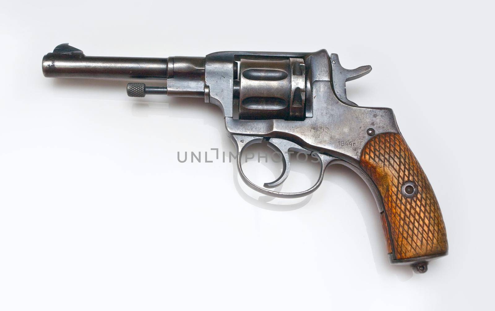 Old revolver on white background