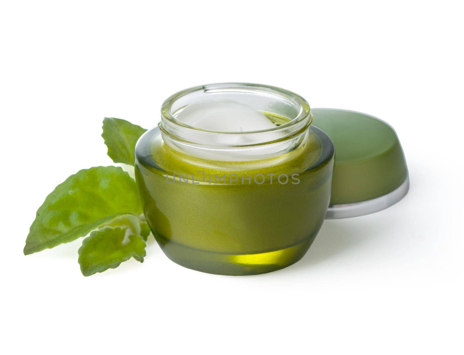 Jars of cream with green leaves isolated on white