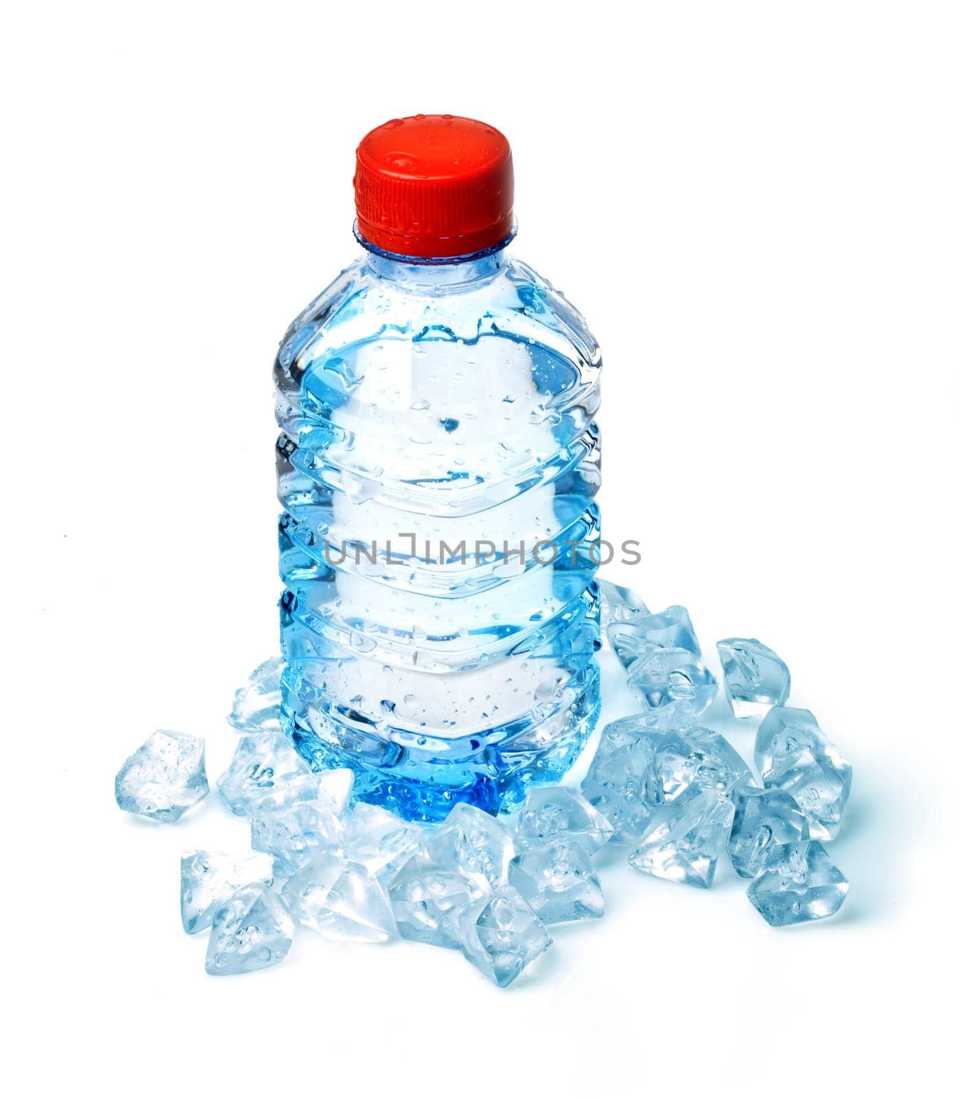 Bottle of water in ice cubes on white background