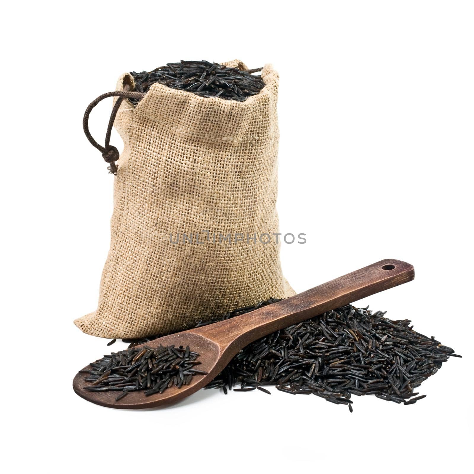 bag of black rice and a wooden spoon on a white background. keeping paths