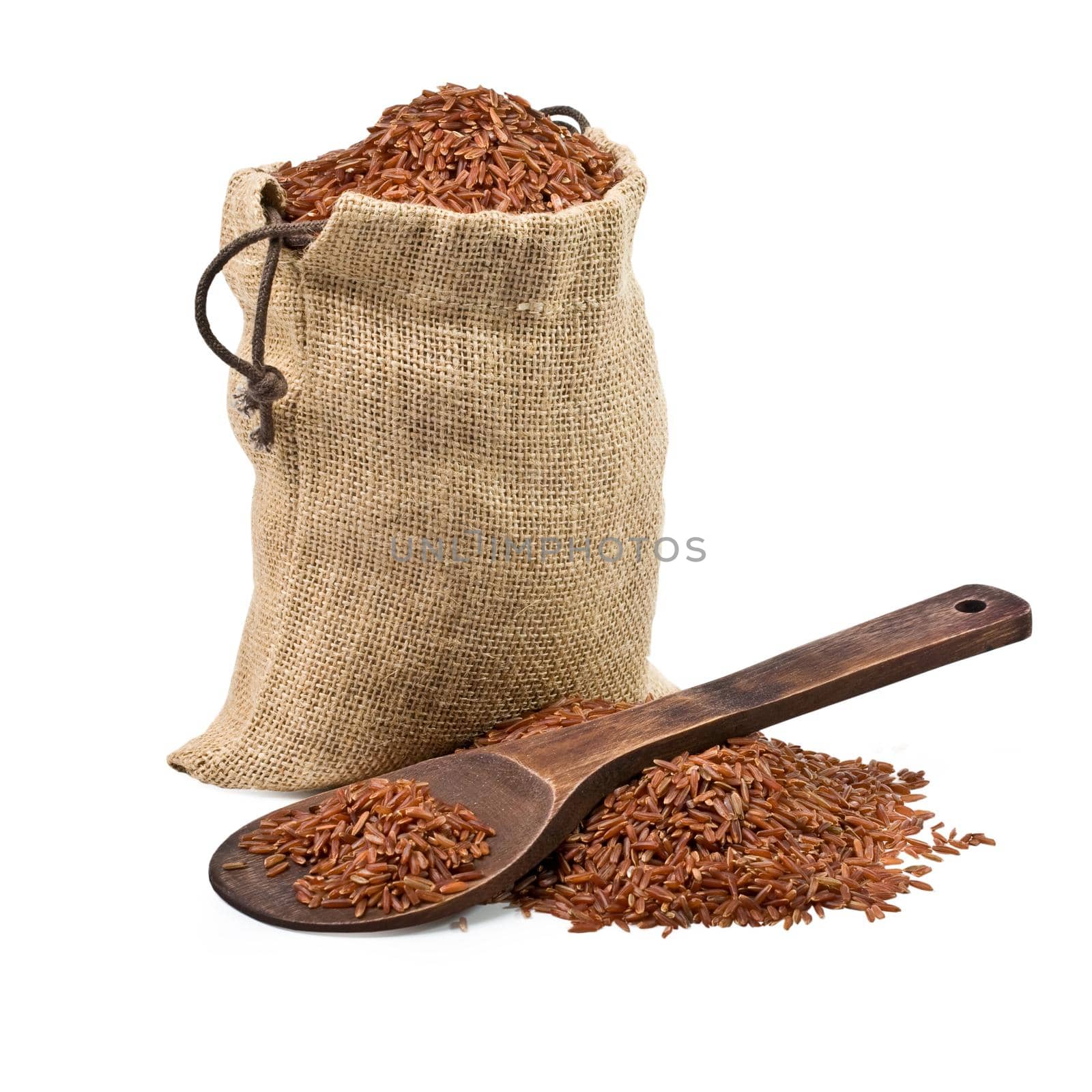 bag of  brown rice and a wooden spoon on a white background. keeping paths