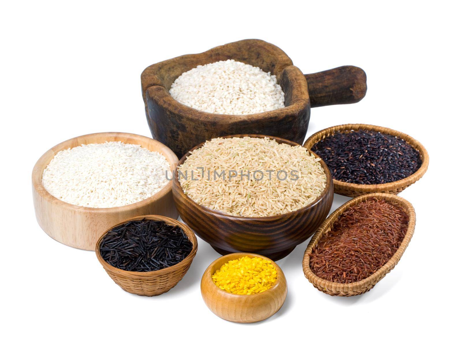 Various kinds of rice in a wooden bowl on a white background