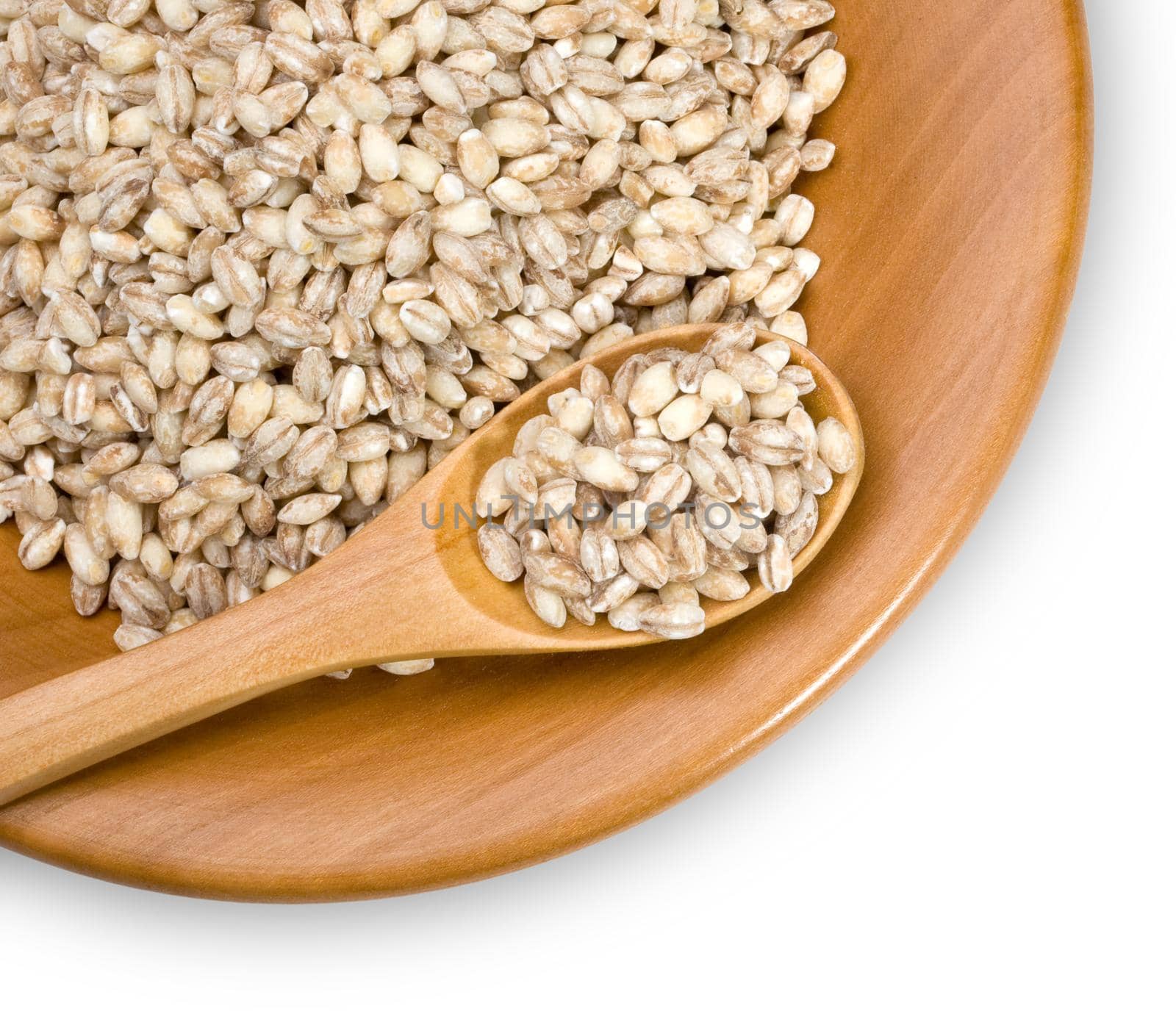 wooden plate with grains of barley close-up