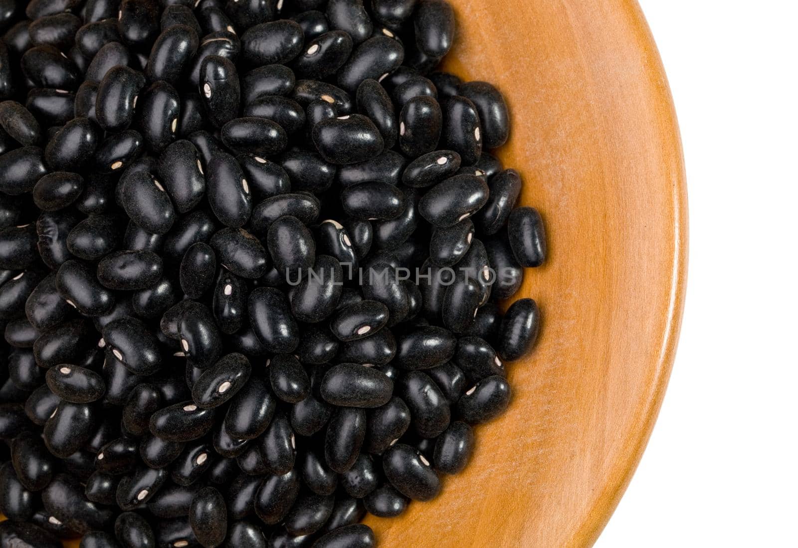 black beans close up in a wooden tray