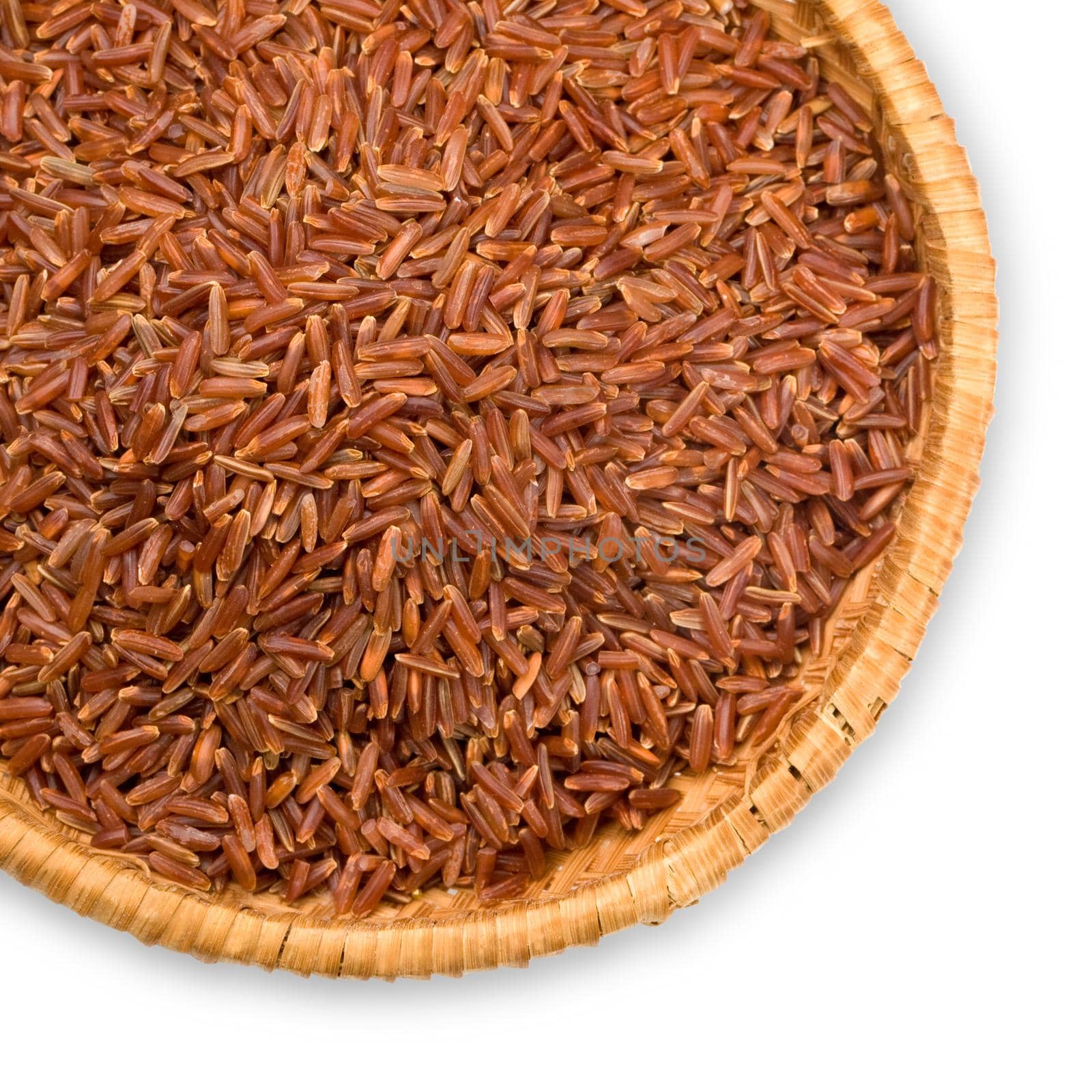 straw plate with long-grain red rice on white background