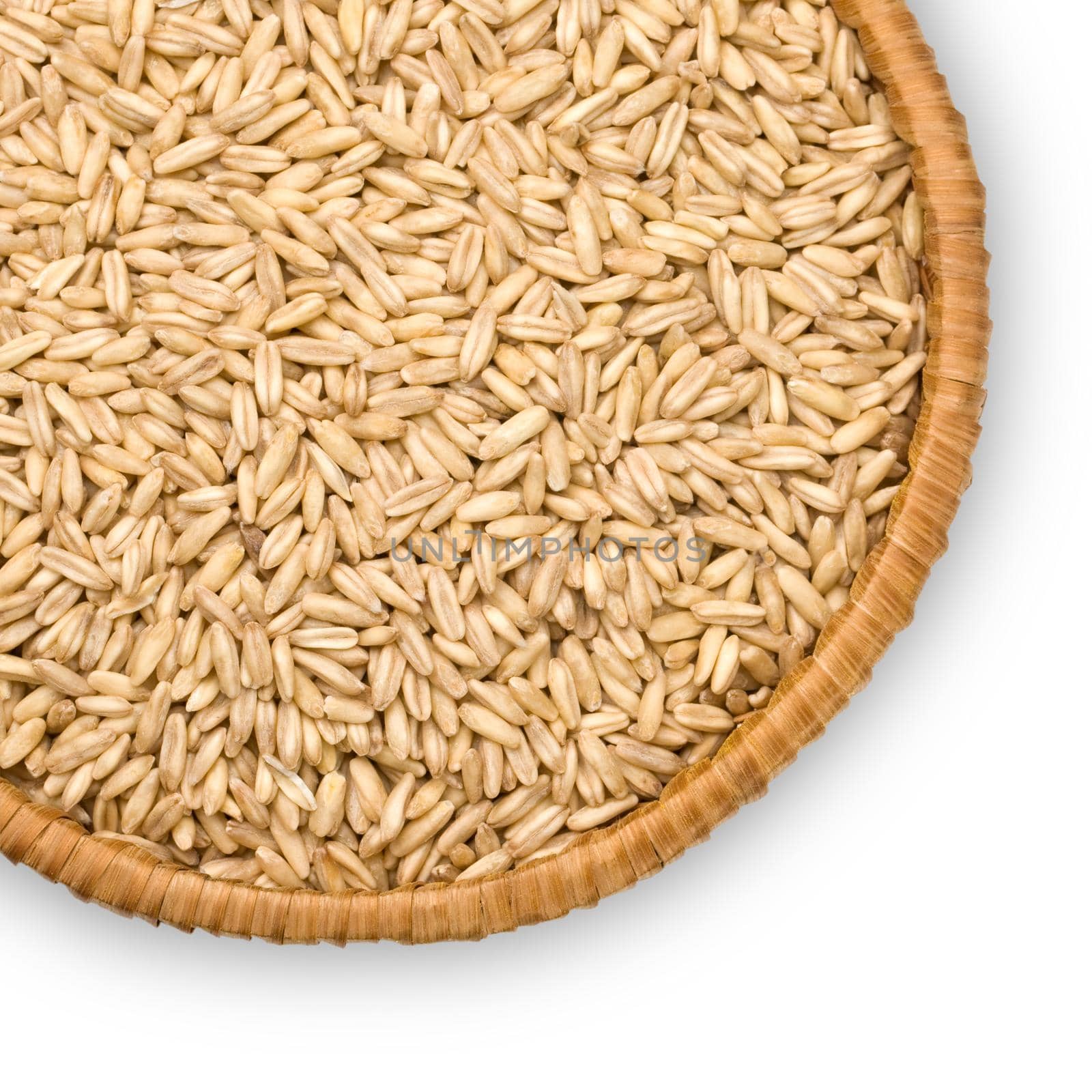  oats close-up on a plate of straw isolated on white background