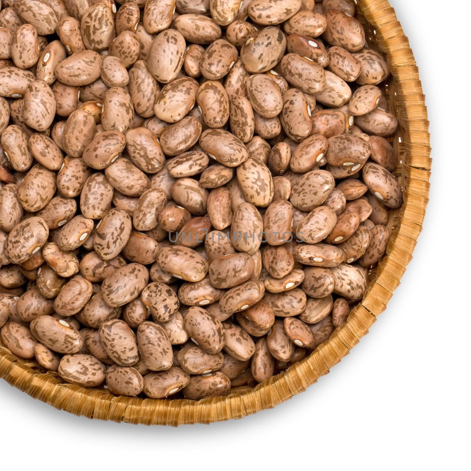 Wicker plate with grains beans close-up on white background