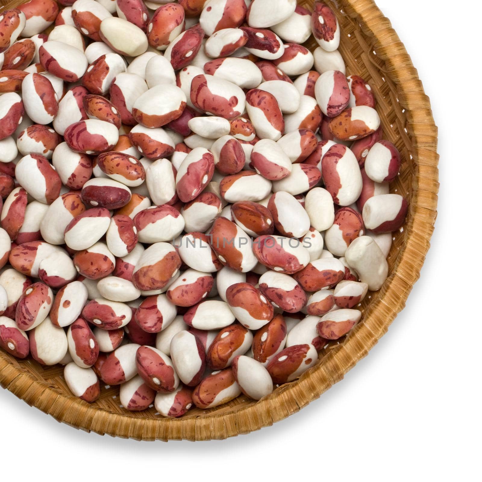 Wicker plate with grains beans close-up on white background