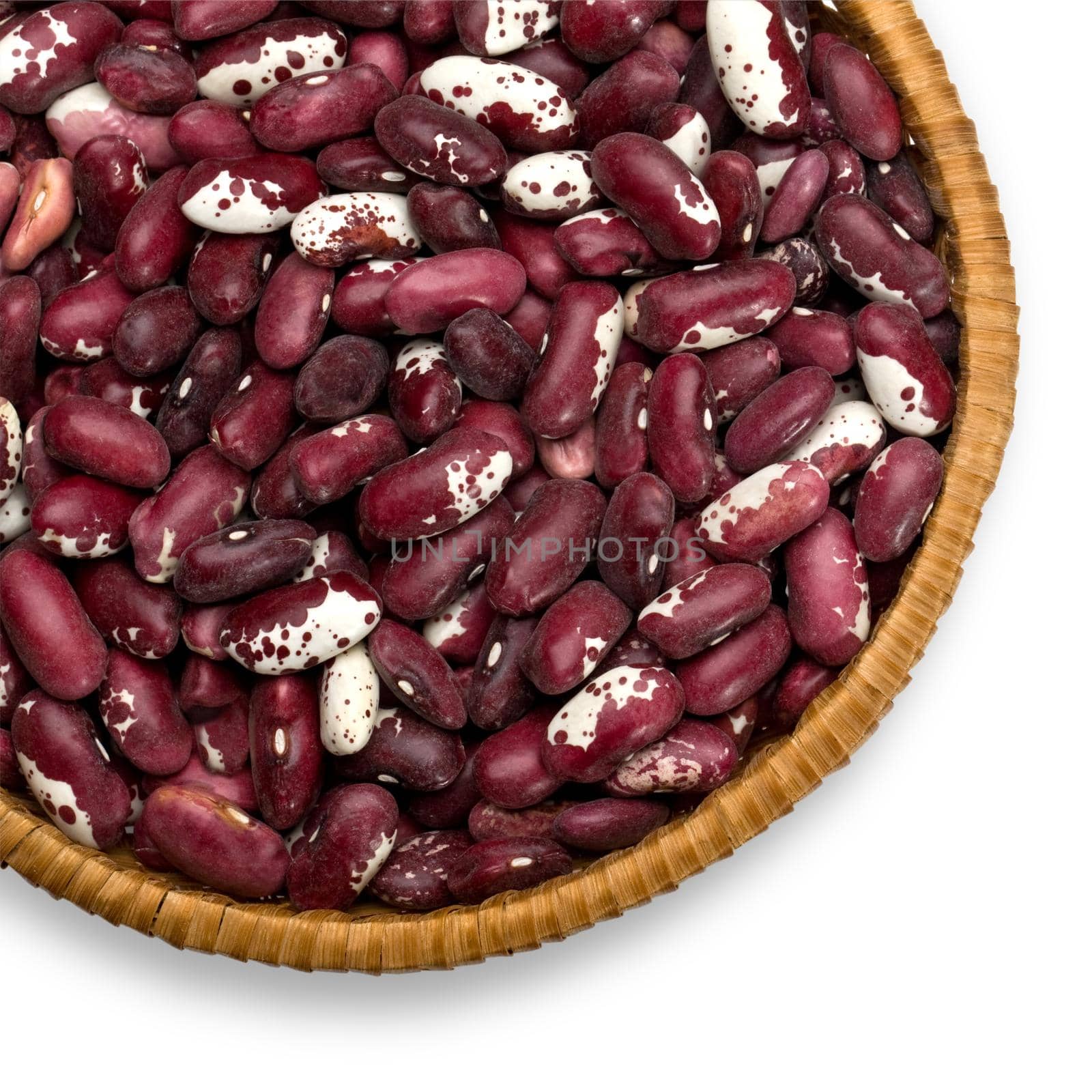 Wicker plate with grains beans close-up on white background