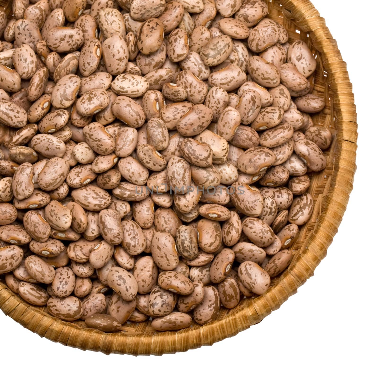 Wicker plate with grains beans close-up on white background