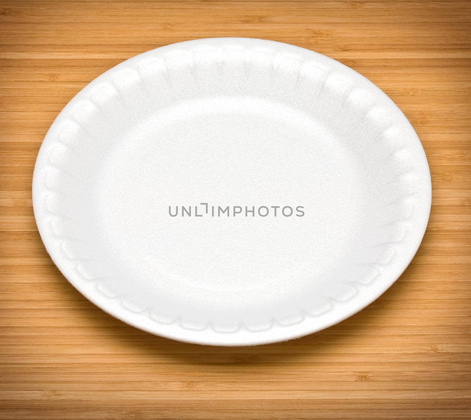 white disposable plates on a wooden table