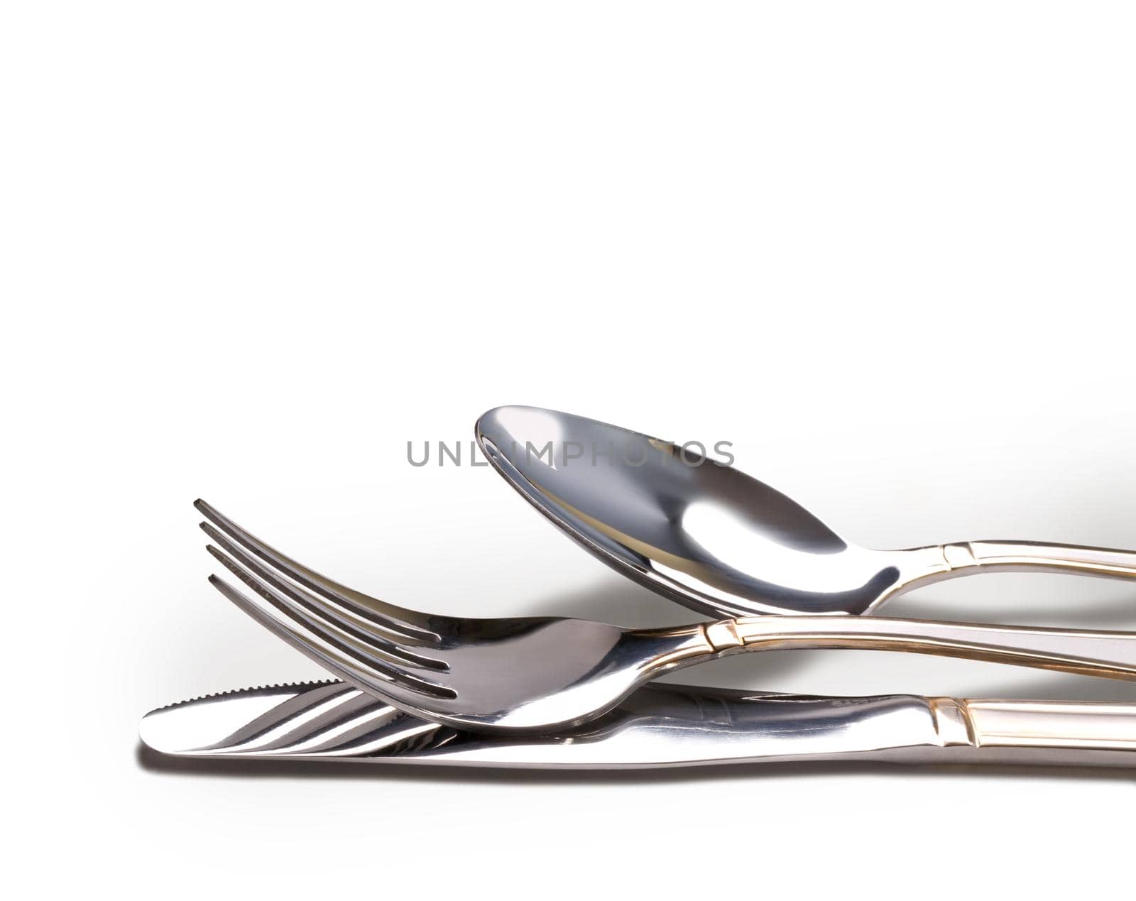 Knife, fork and spoon isolated on white