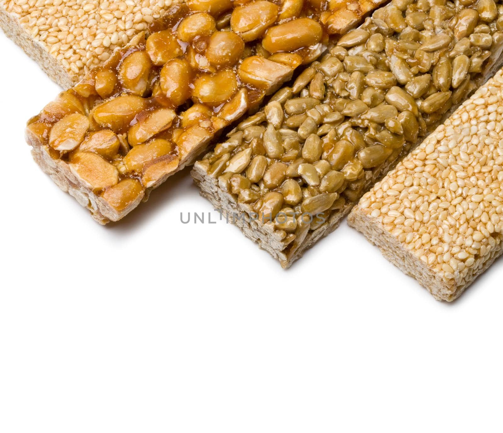 sunflower seeds, sesame ,peanuts in sugar syrup isolated on a white background