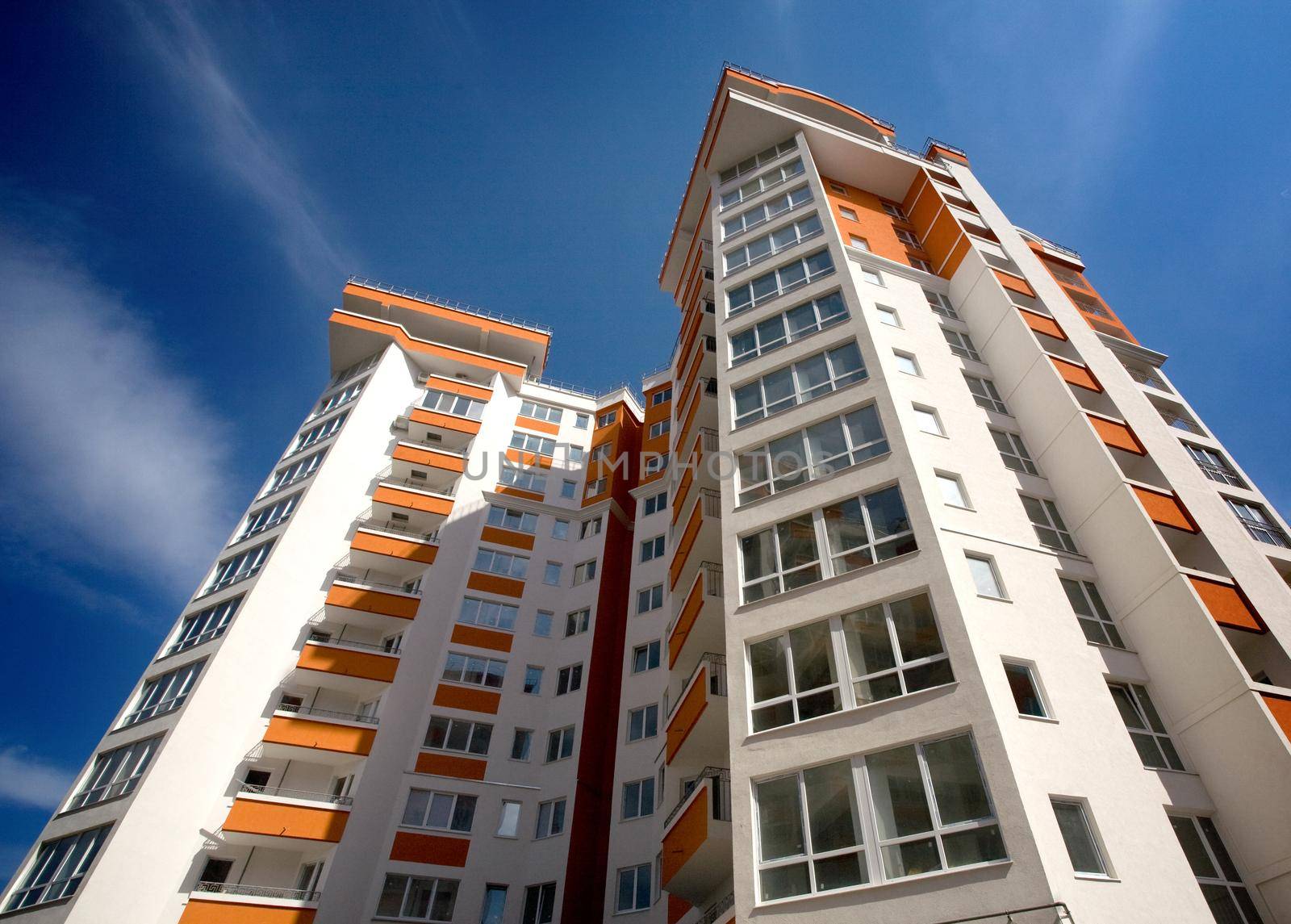 Modern apartment building against blue sky background