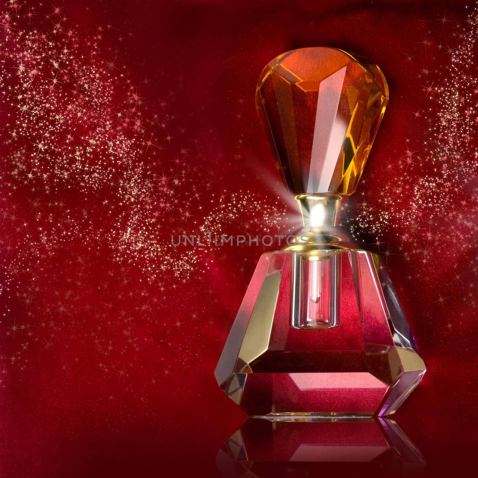 bottle of perfume on a dark red background