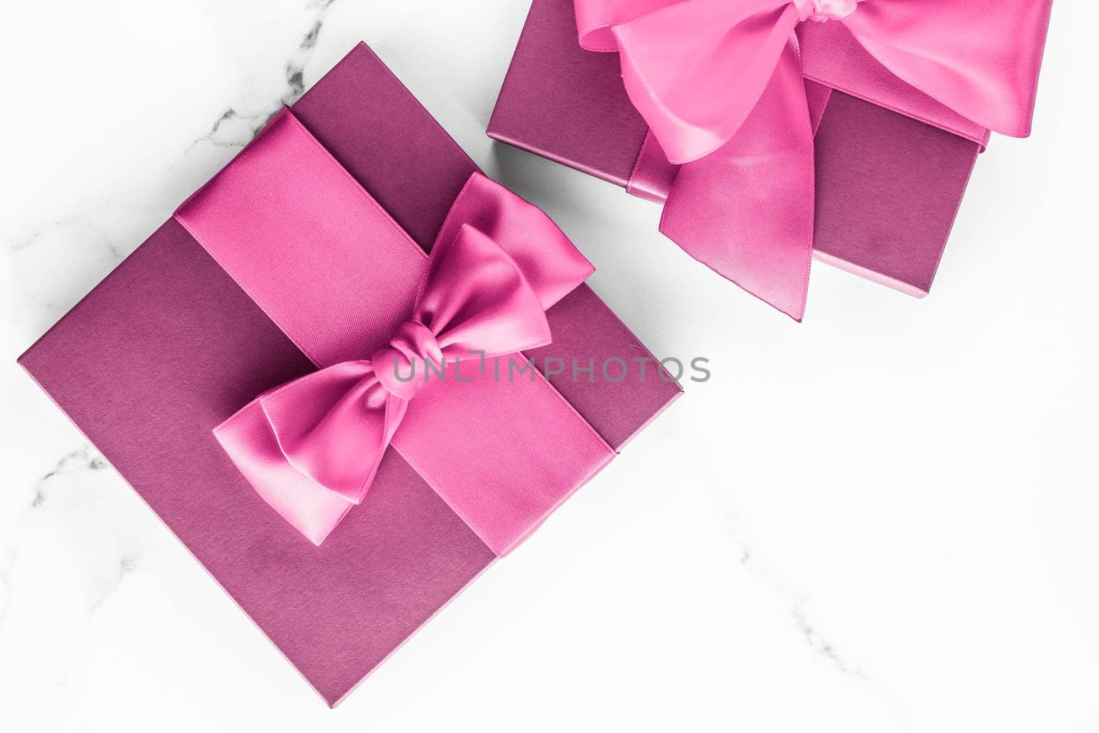 Birthday, wedding and girly branding concept - Pink gift box with silk bow on marble background, girl baby shower present and glamour fashion gift for luxury beauty brand, holiday flatlay art design