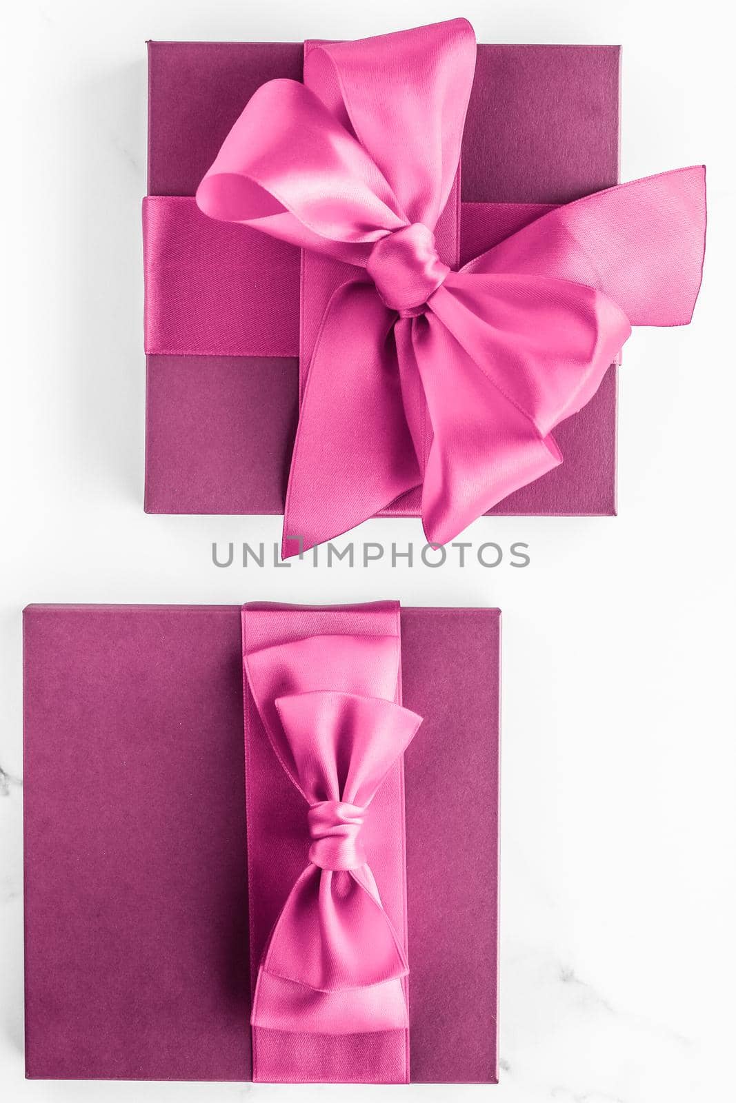 Birthday, wedding and girly branding concept - Pink gift box with silk bow on marble background, girl baby shower present and glamour fashion gift for luxury beauty brand, holiday flatlay art design