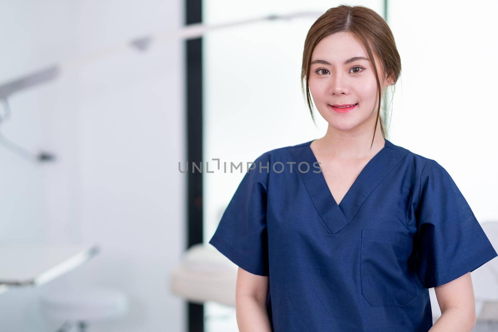 Beauty clinic worker stand with confidence action in workplace area and looking at camera. Beauty business for good appearance to people concept.