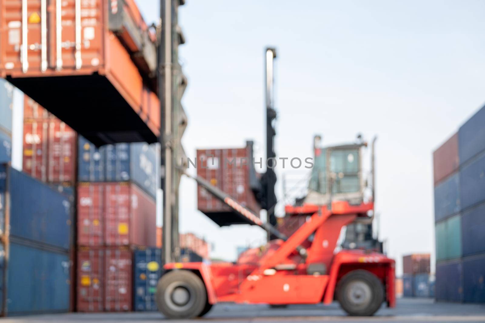 Blurred image of crane truck level up cargo container tank and move to other area in workplace. Concept of background image for incorporate to news of other media.