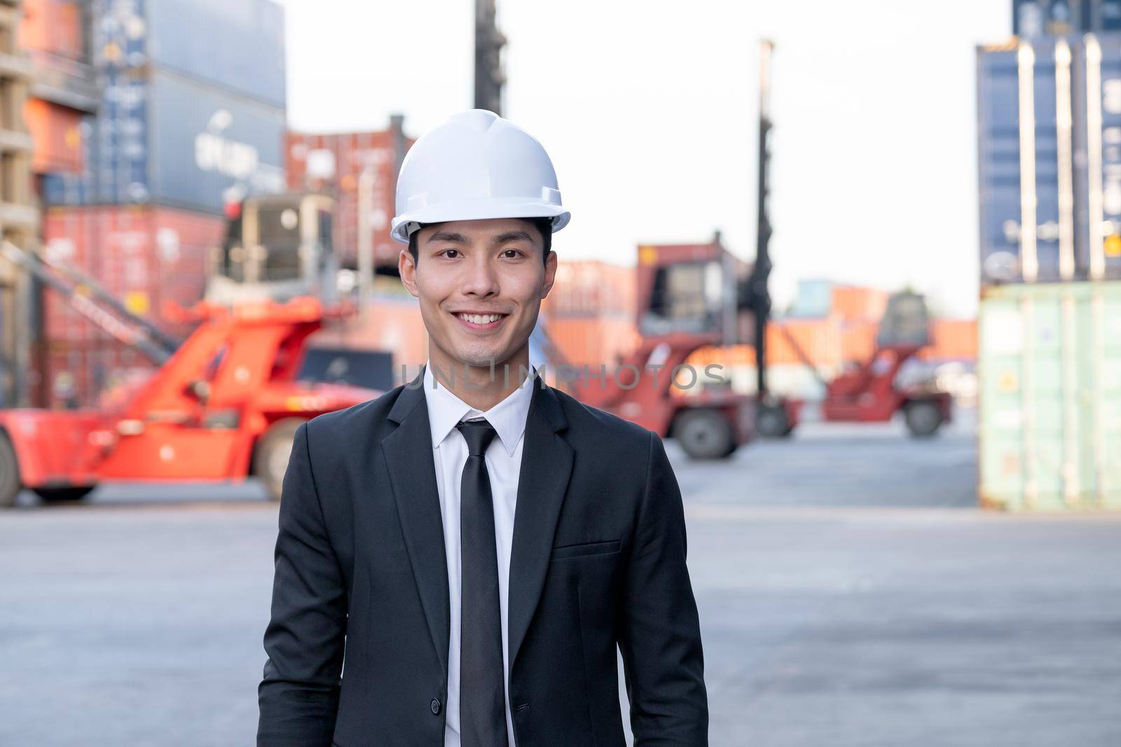 Portrait of engineer worker of factory technician with Chinese style man stand with confidence action and smile in workplace area. Concept of good support best successful for industrial business.